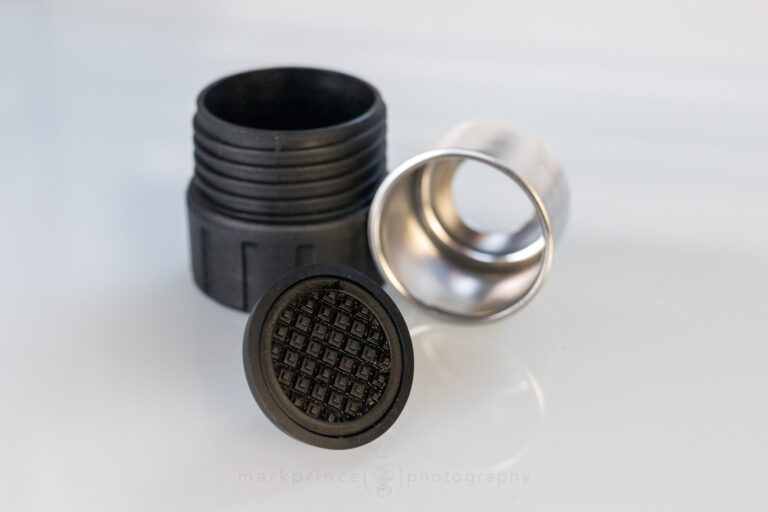 The portafilter components of the brewer - PF, filter basket, filter.