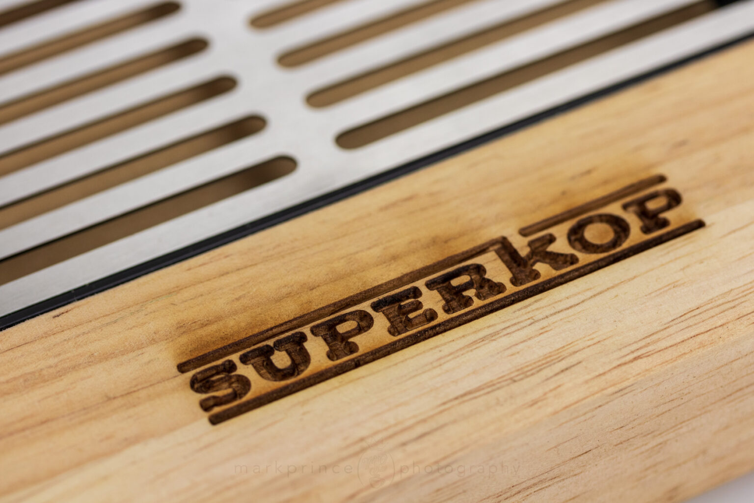 Burned in logo detail on the Superkop wood base