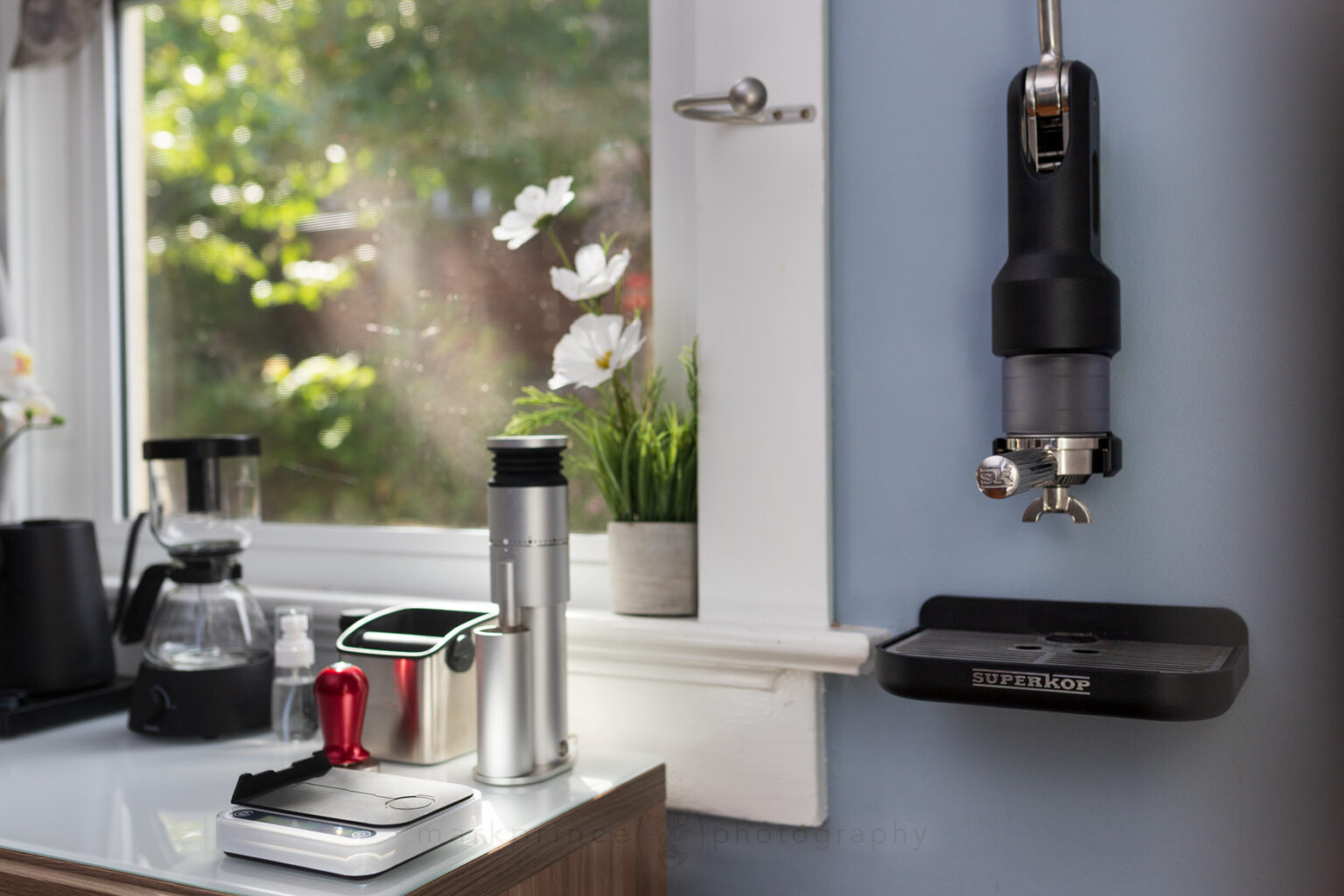 A brewing station at home with a wall mounted espresso machine.