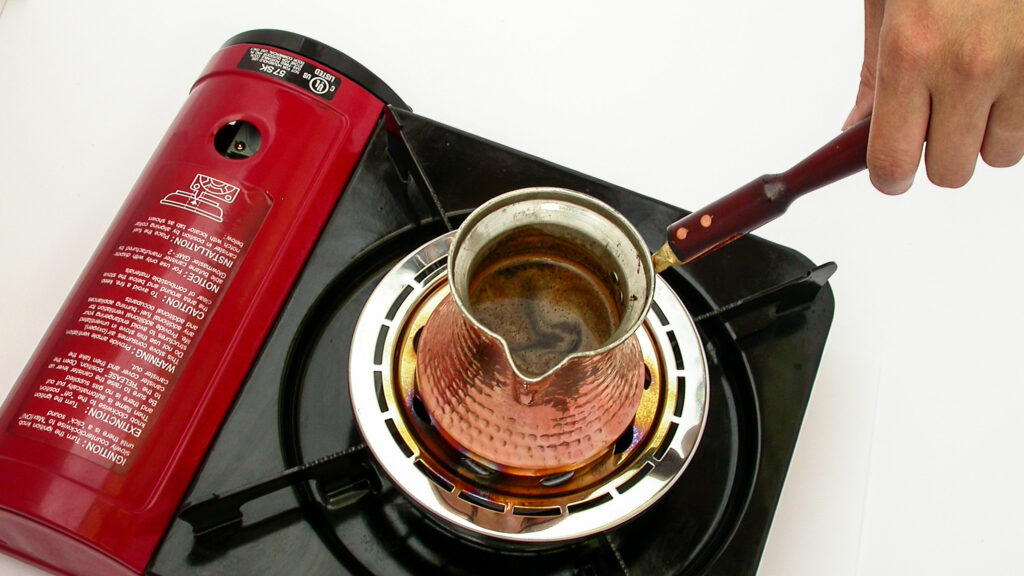 Making Turkish Coffee with an ibrik, on a portable stove.