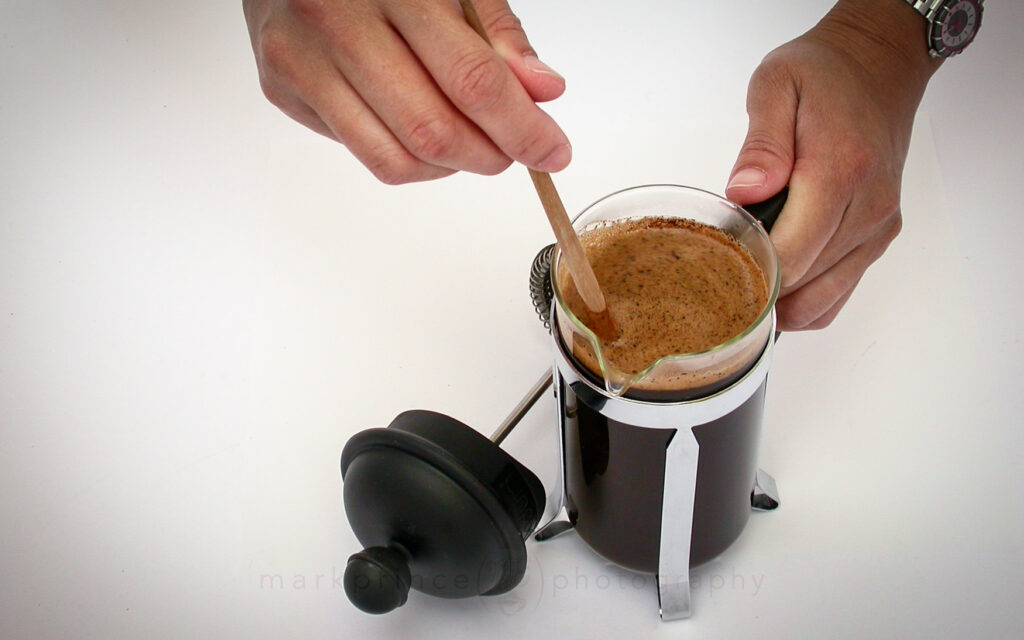 Demonstrating brewing with a press pot, a 3 cup model.