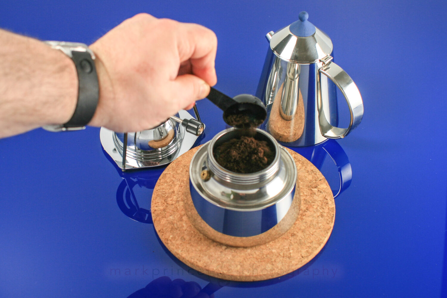 Adding coffee to the grounds chamber on a moka pot.